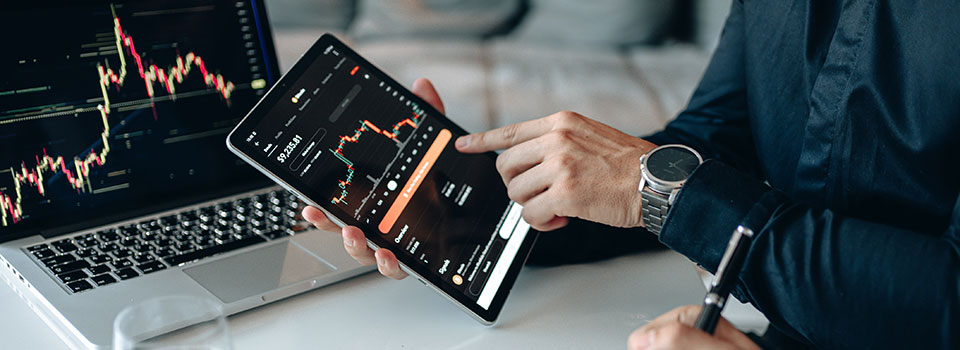 Hand pointing to investor information on a tablet